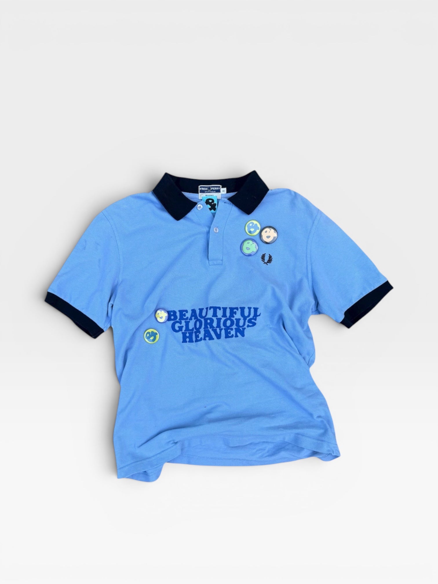 andvamos Heaven Polo — reworked screen-printed HEAVEN polo, front view