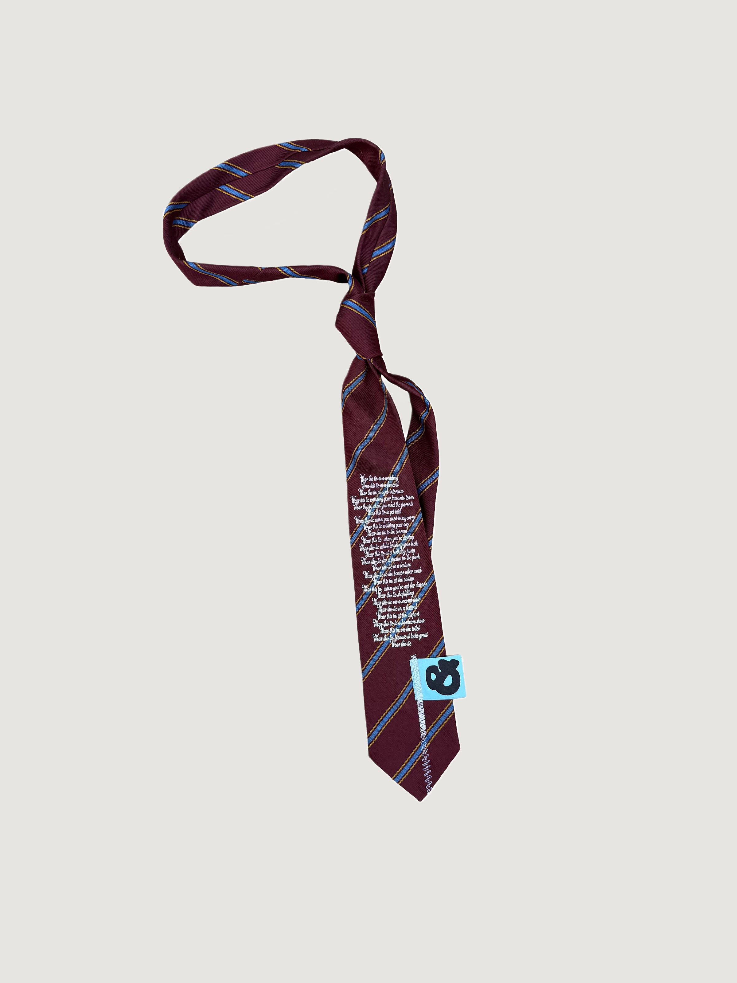 Reworked maroon striped poem-print tie by andvamos on a grey background