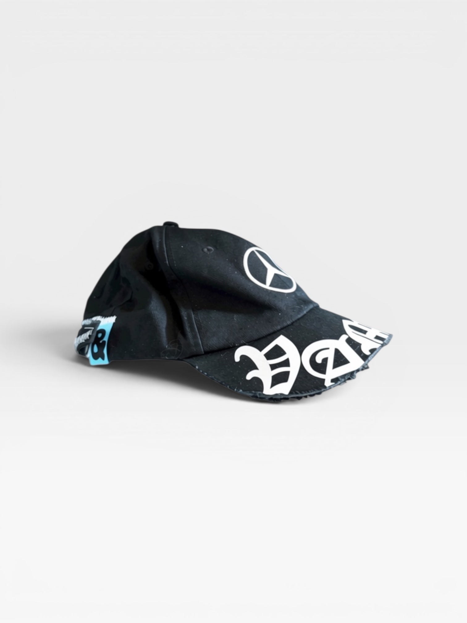 andvamos Motor Cap — distressed black cap with &vamos badges, side view