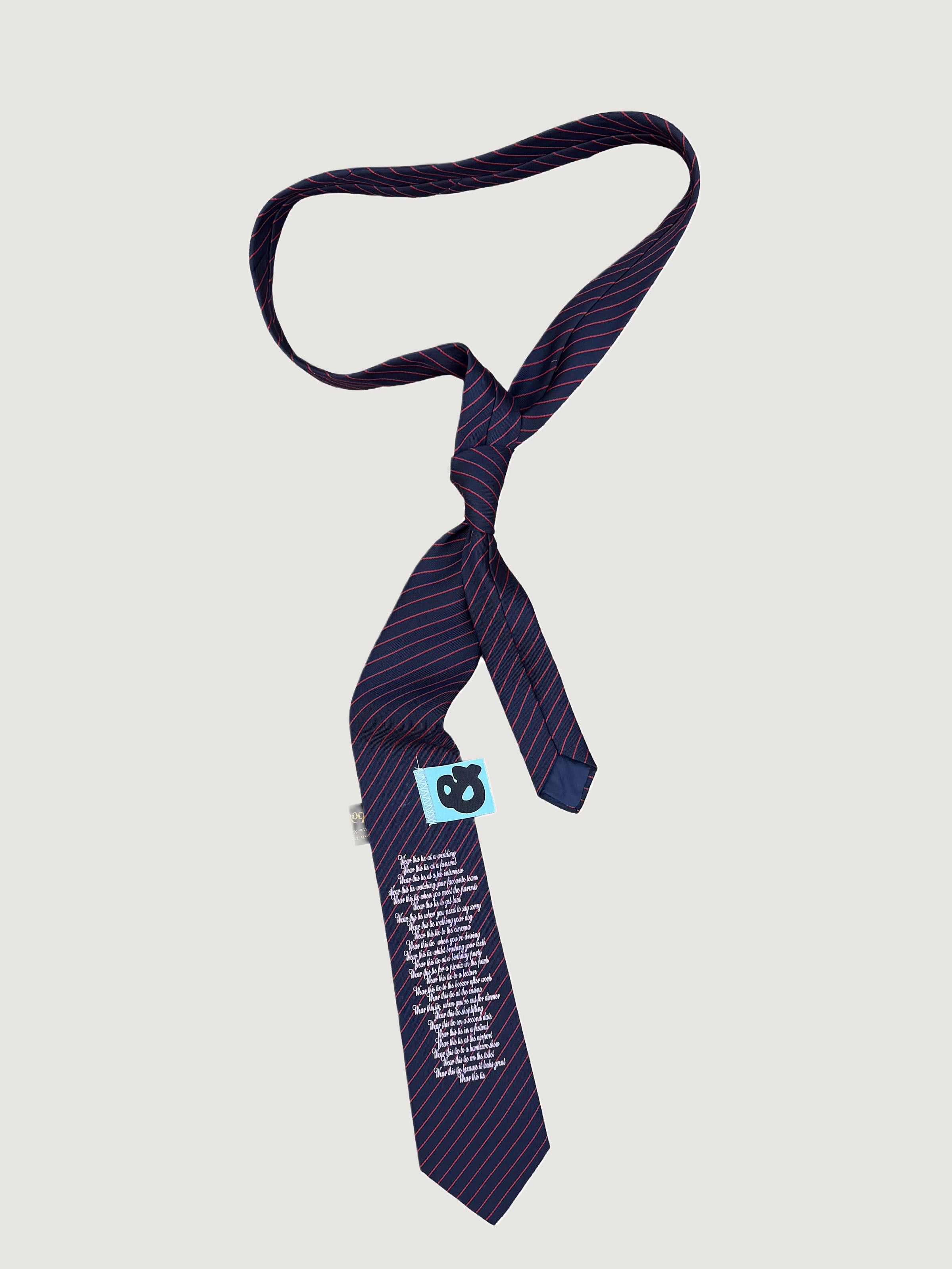 Reworked navy pinstripe poem-print tie by andvamos on a grey background